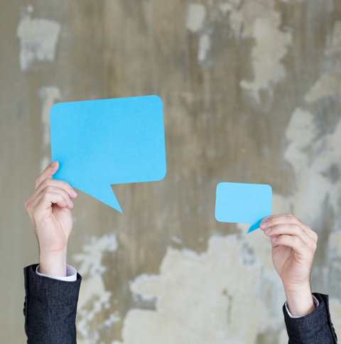 Blue speech bubbles to represent a conversation