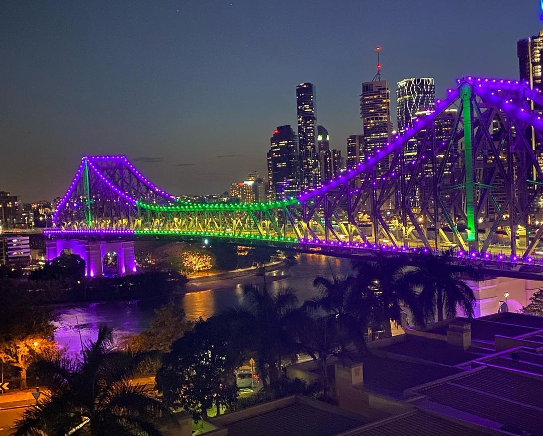 Story Bridge lit in purple and green